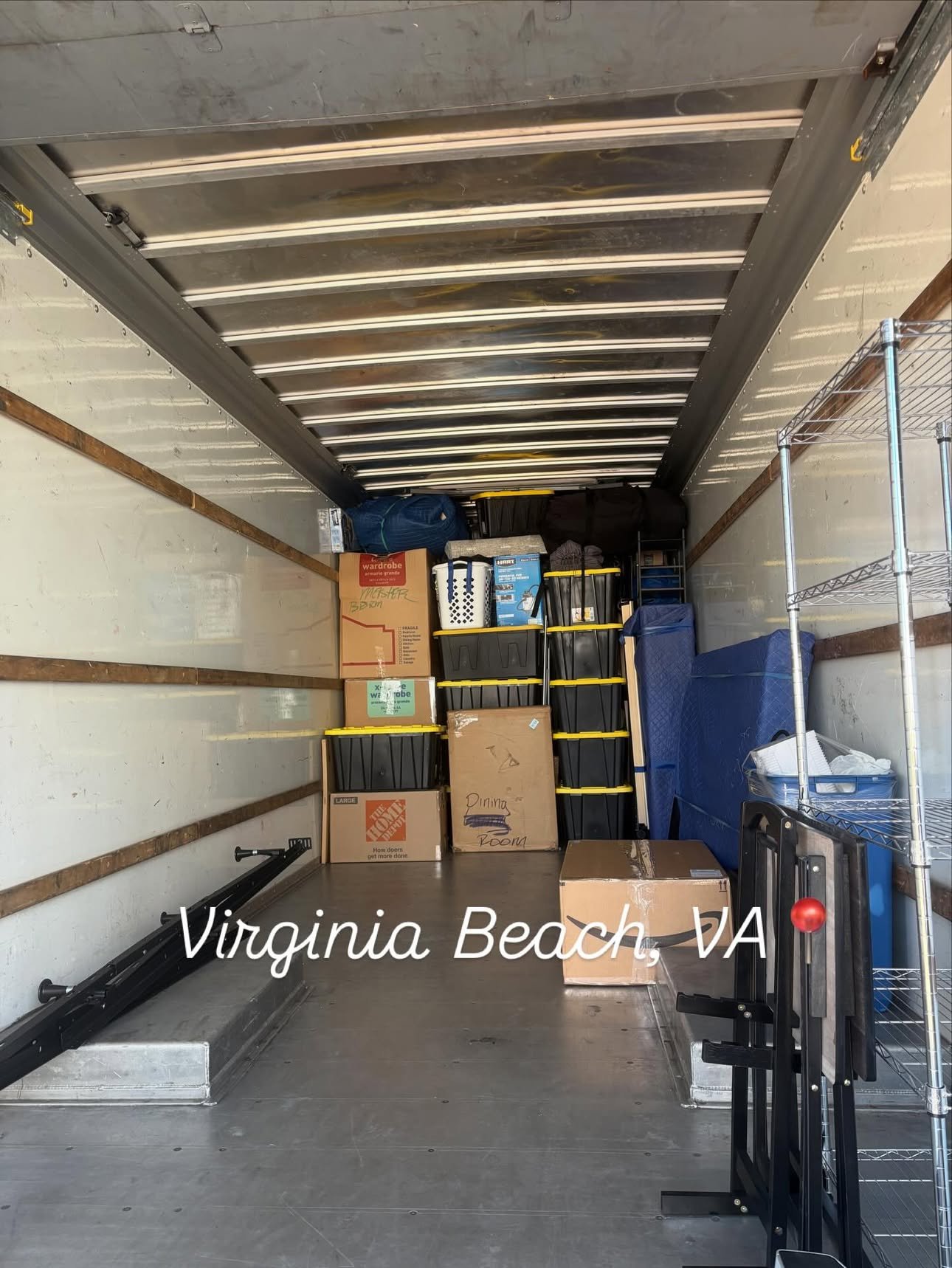 Neatly loaded Anchor Arm moving truck, boxes and totes stacked and secured, on a Virginia Beach job